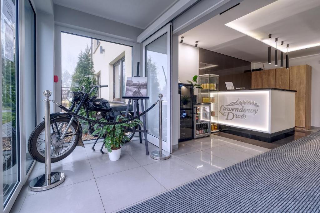 a motorcycle parked in a room with glass doors at Lawendowy Dwór in Pszczółki