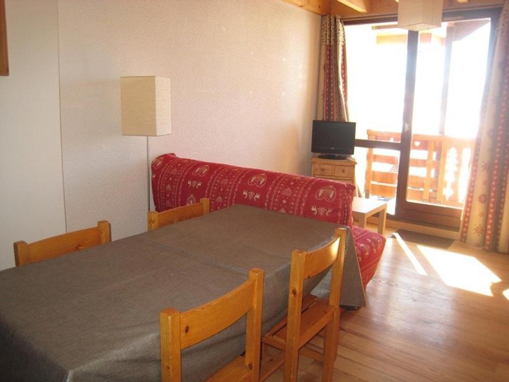un salon avec une table et un canapé dans l'établissement Appartement cosy 5 pers avec balcon sud à l’Alpe d’Huez, skis aux pieds - FR-1-405-28, à L'Alpe-d'Huez