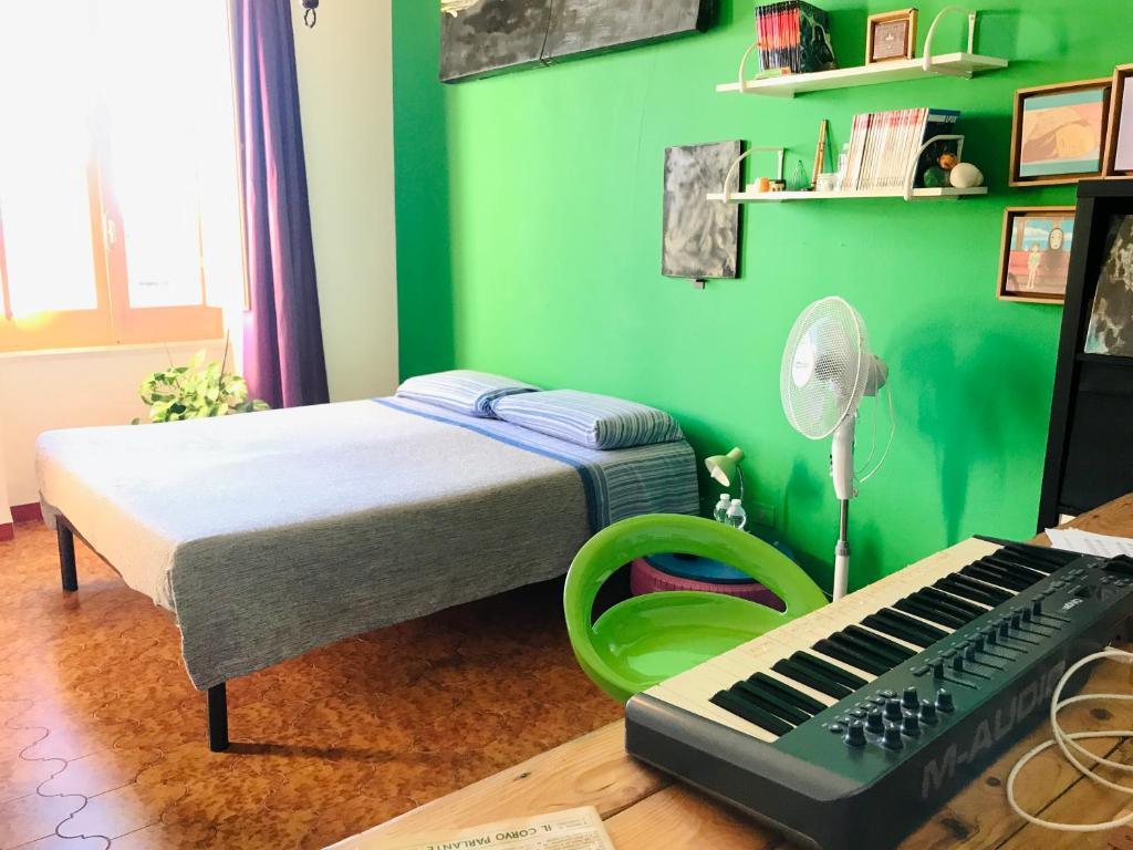 Dormitorio pequeño con cama y teclado en Casa Matilda, en Berchidda