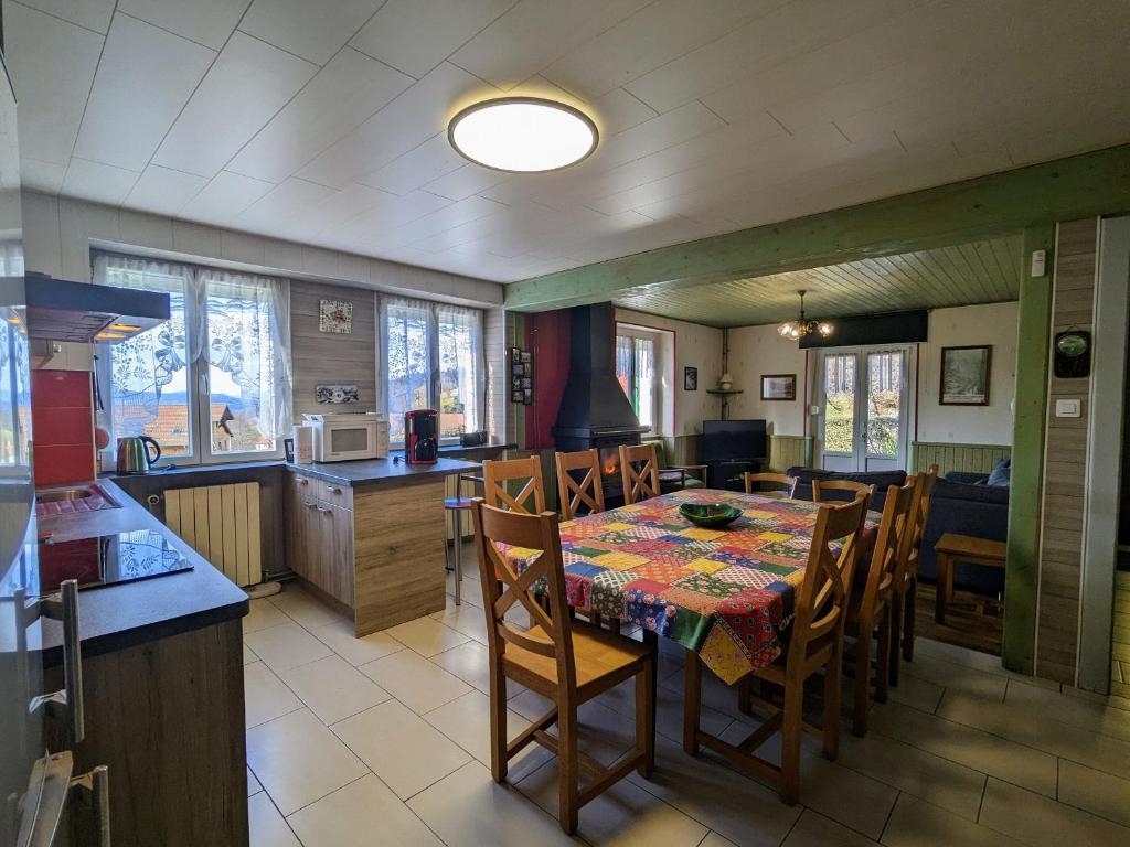 a kitchen and dining room with a table and chairs at Gîte spacieux en ancienne ferme rénovée, idéal pour familles et amis – proche randos et sites touristiques - FR-1-589-6 in Ban-sur-Meurthe-Clefcy