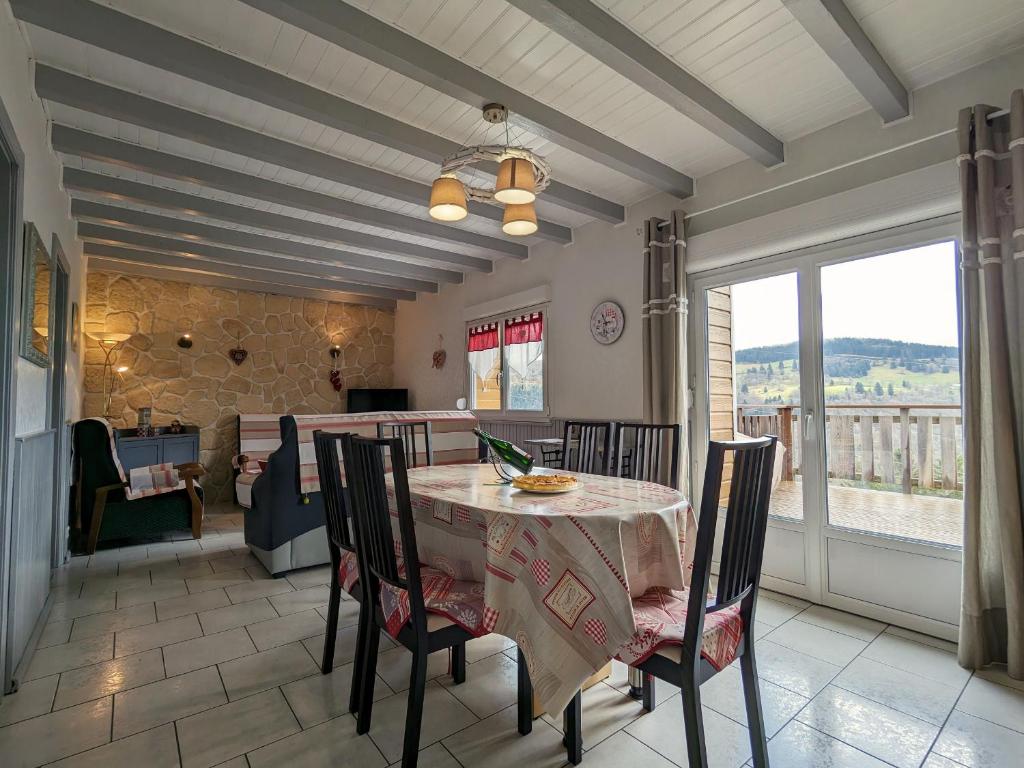 a dining room with a table and chairs at Charmant chalet de montagne avec terrasse et vue imprenable - FR-1-589-72 in Cornimont