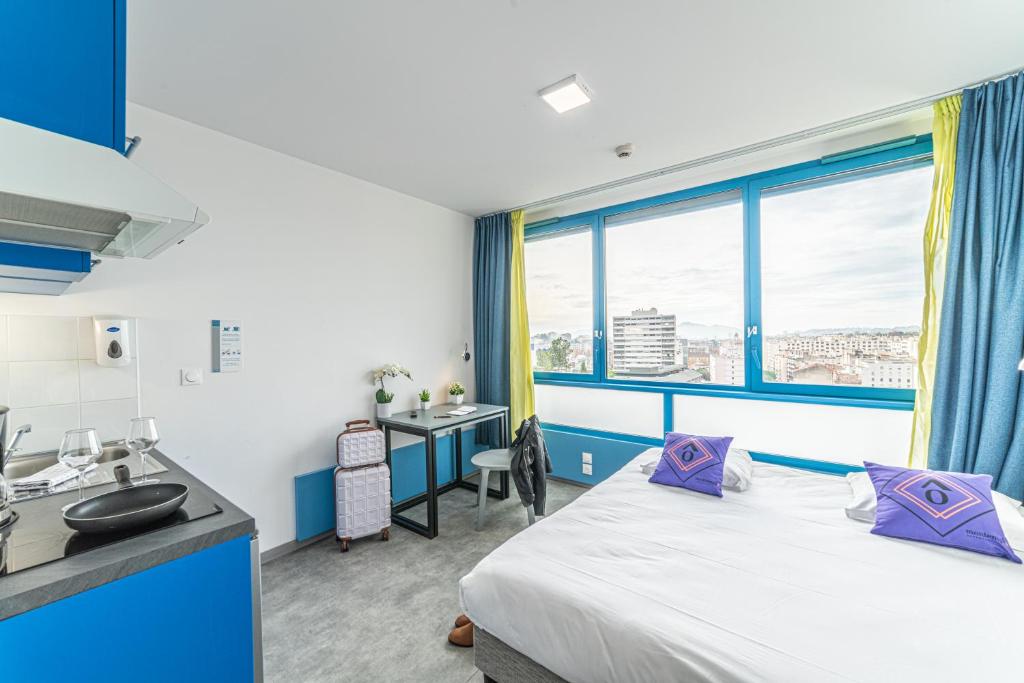 a bedroom with a bed and a sink and a window at Montempô Marseille Centre Dôme in Marseille