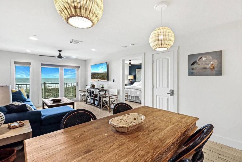 a living room with a table and a blue couch at Grand Caribbean 4007 in Port Aransas