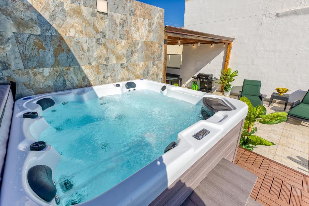 a jacuzzi tub in a yard with a patio at Sliema Luxury House in Sliema