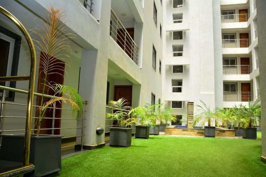 a courtyard with potted plants in a building at The Moon Apartments in Mutomo