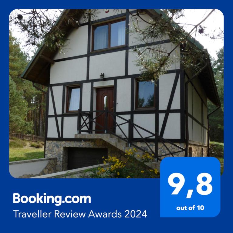 a house with a sign that reads travel review awards at Raduńska Ostoja in Dziemiany