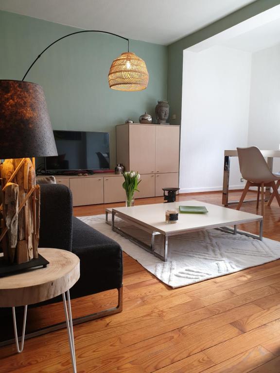 a living room with a couch and a coffee table at Happiness Cottage in Colmar
