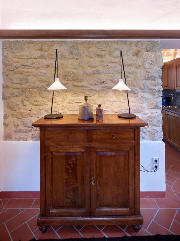 dwie lampy na drewnianym gablocie w kuchni w obiekcie Agriturismo Podere Cortilla w mieście Volterra