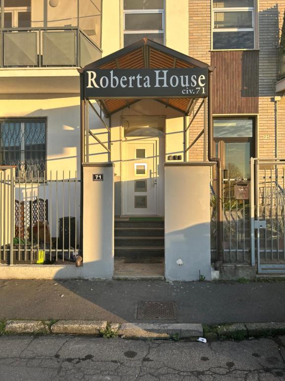 a roberta house with a sign in front of it at Roberta House Rozzano 2 in Rozzano