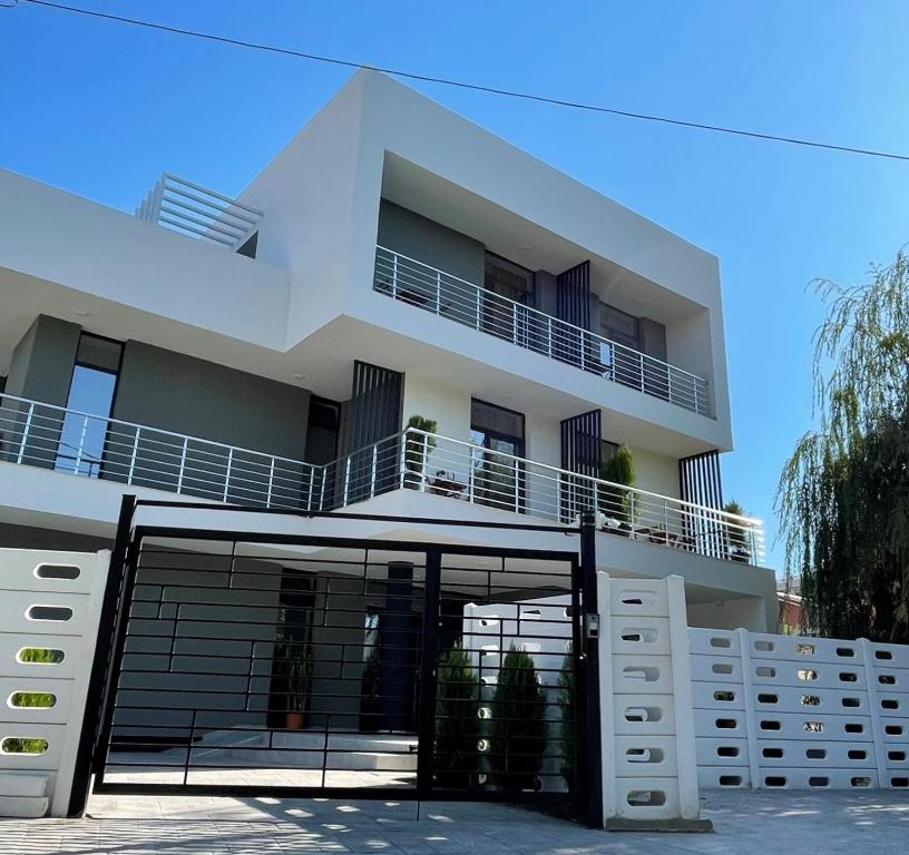a white apartment building with a large garage at EOS - Eforie Nord in Eforie Nord
