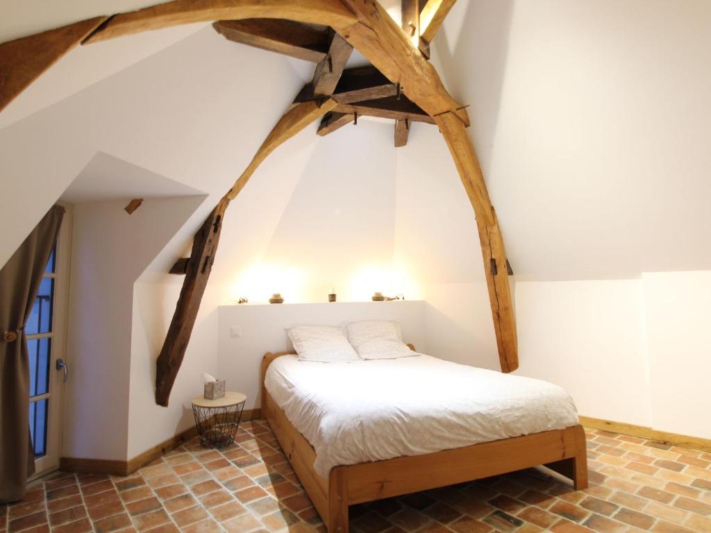 a bedroom with a bed in the attic at Gîte Baugé en Anjou, 5 pièces, 6 personnes - FR-1-622-29 in Baugé-en-Anjou