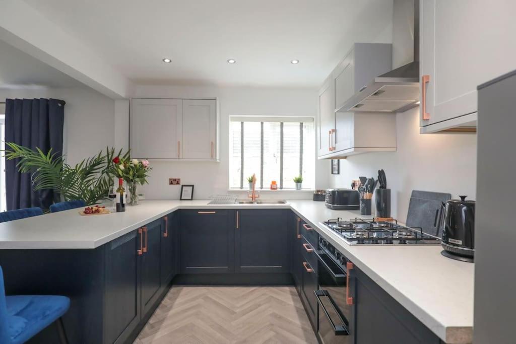 a kitchen with black cabinets and white counter tops at Perfect for Contractors with on site parking in Brettell Lane