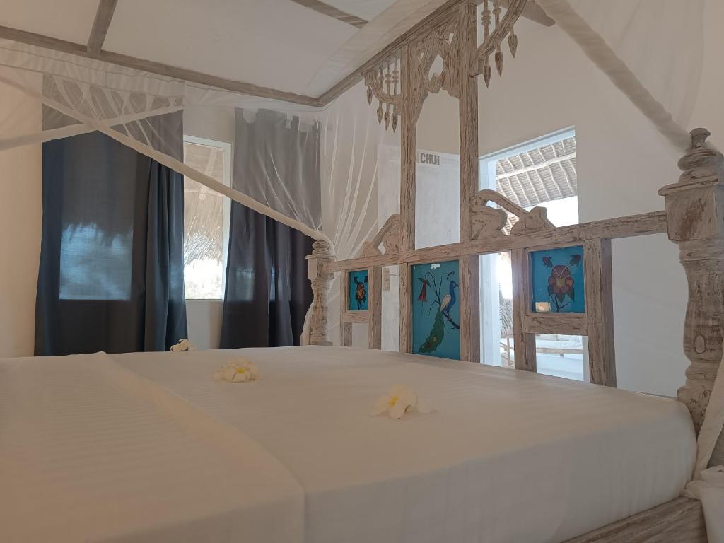 Postel nebo postele na pokoji v ubytování Pole Pole Beach House