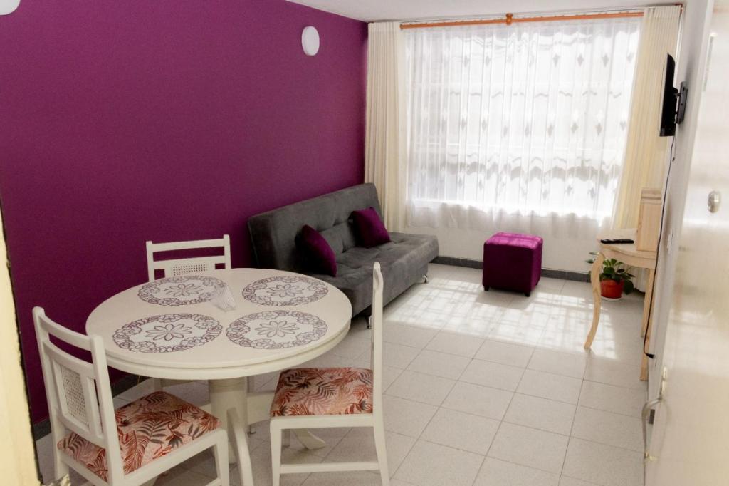 a living room with a table and a couch at Apartamento cerca centro bogota in Bogotá