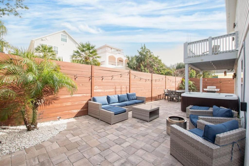 a patio with couches and a wooden fence at 4BR house, 2 blocks from the beach in Saint Augustine