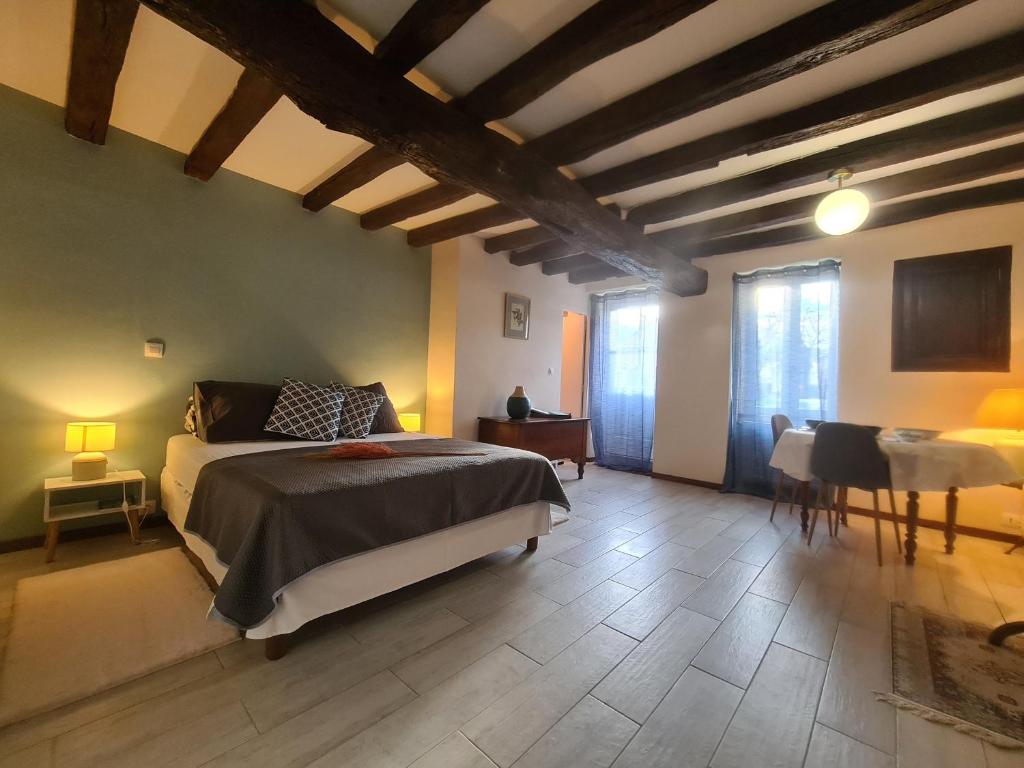 a bedroom with a bed and a table and chairs at Guestroom Nohant-Vic, 1 pièce, 2 personnes - FR-1-591-391 in Nohant-Vic