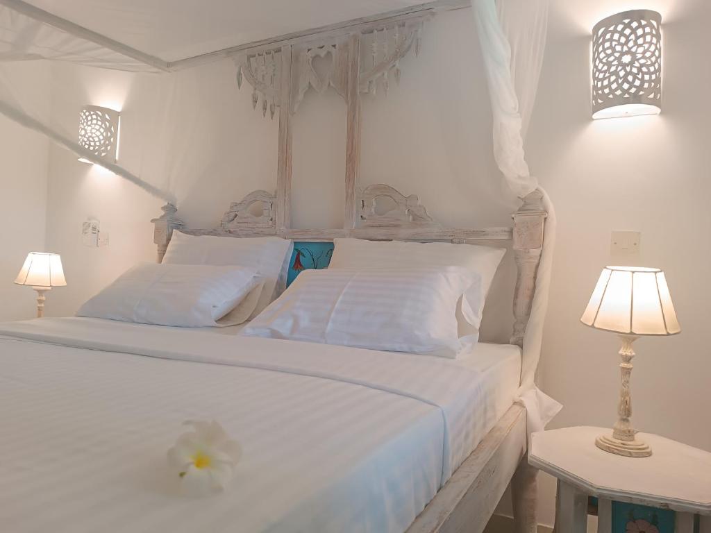 Postel nebo postele na pokoji v ubytování Pole Pole Beach House