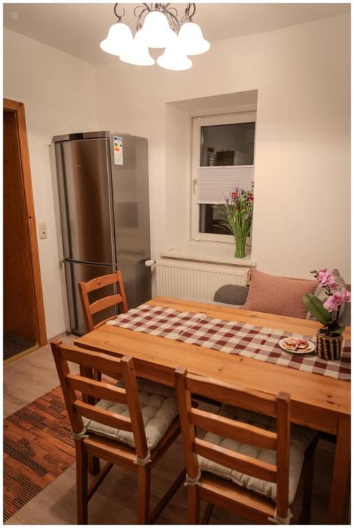 a kitchen with a wooden table and a refrigerator at Appartement Franz in Bad Ischl