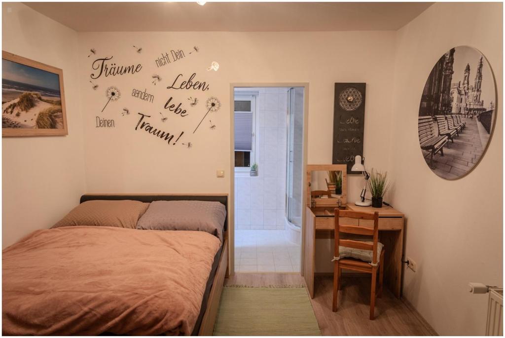 a bedroom with a bed and a desk with a desk at Appartement Franz in Bad Ischl