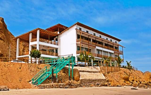 a building on top of a hill next to a beach at Punta Pico in Bocapán