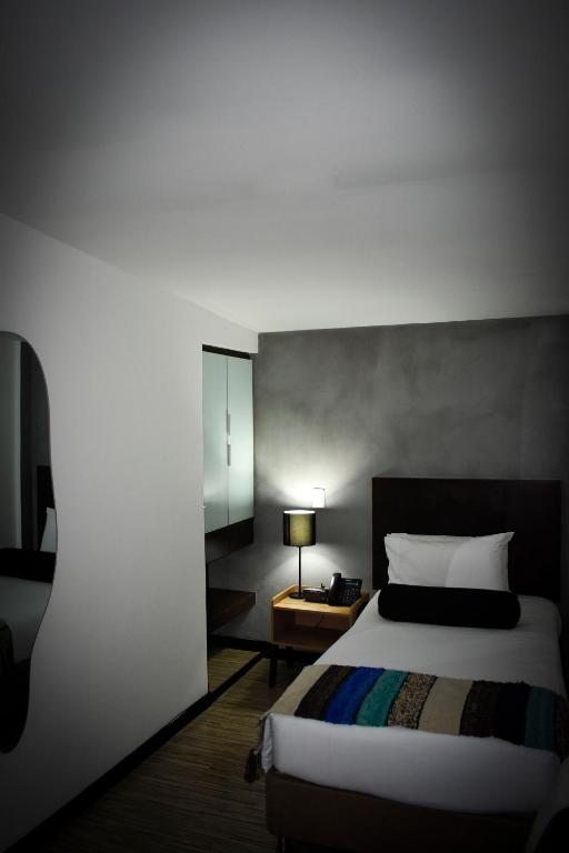 Postel nebo postele na pokoji v ubytování Hotel DC Feria