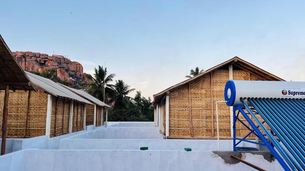 a group of buildings with a playground in front of them at Greenstone Resort Hampi in Hampi