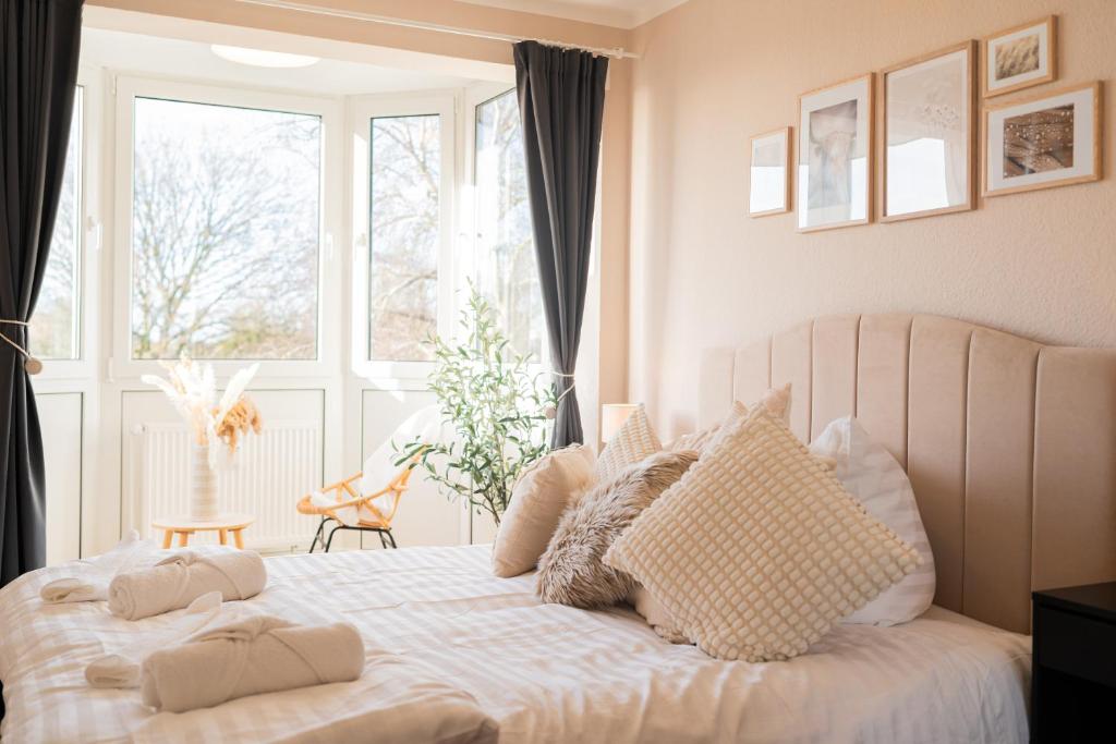 a bedroom with a white bed with pillows and a window at Dein Ruhepol an der Nordseeküste mit Sauna in Cappel-Neufeld