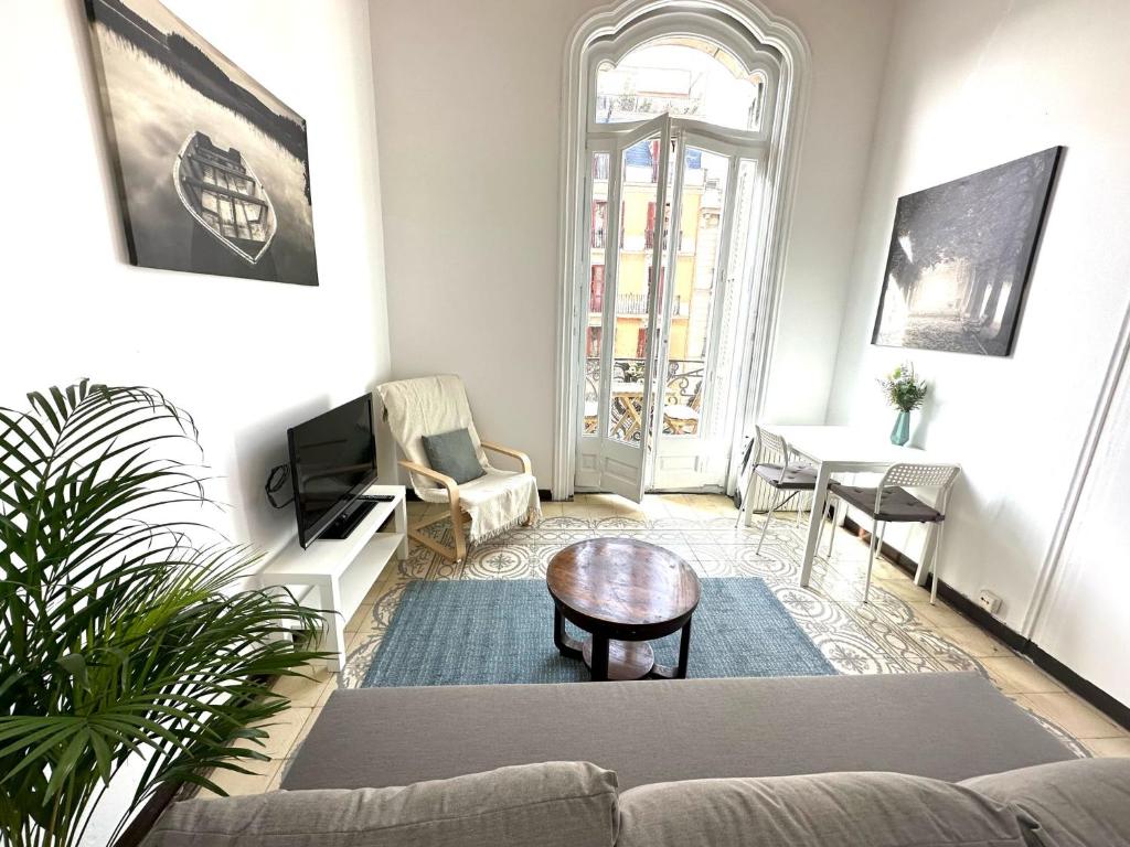 a living room with a couch and a table at Barcelona Central Apartments in Barcelona
