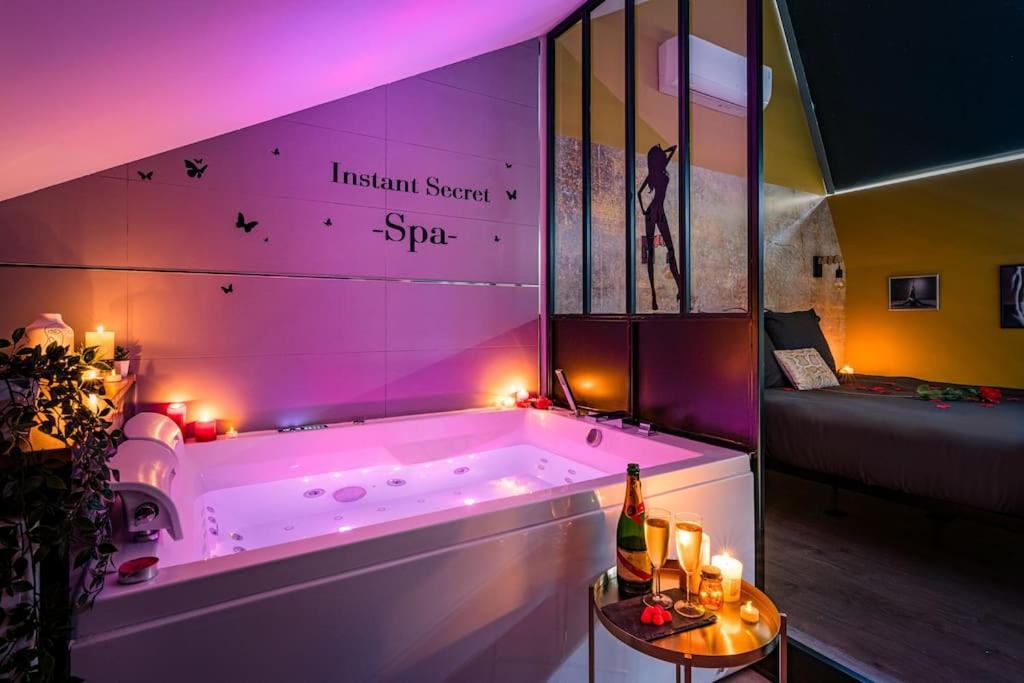 a large bath tub with lights in a room at Duplex coup de coeur in Bourgoin
