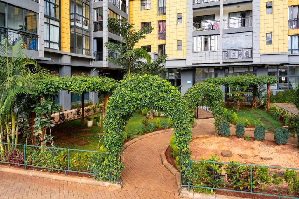 an apartment complex with a garden in the middle at Sylver Harbour 2 Bedroom Apartment in Nairobi