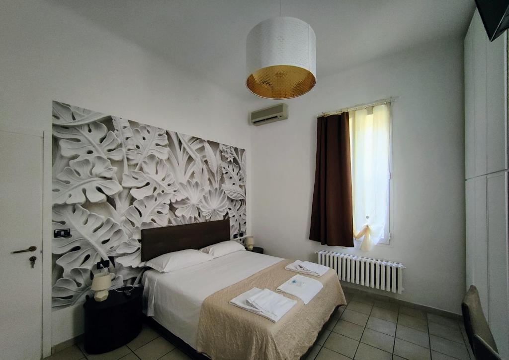 Łóżko lub łóżka w pokoju w obiekcie B&B Villa Rivabella