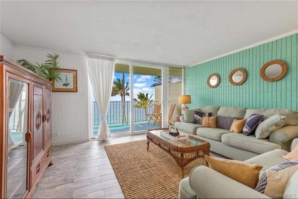 a living room with a couch and a table at Beautiful Beachfront Condo in Laie