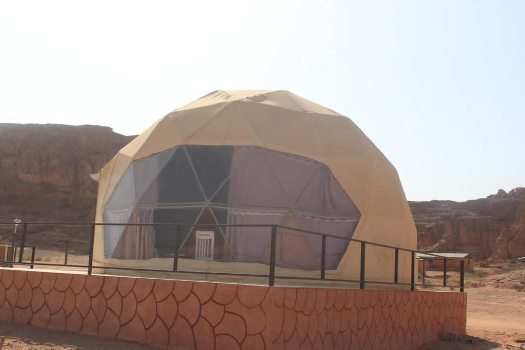 a dome tent in the middle of the desert at wadi rum fox road camp & jeep tour in Wadi Rum