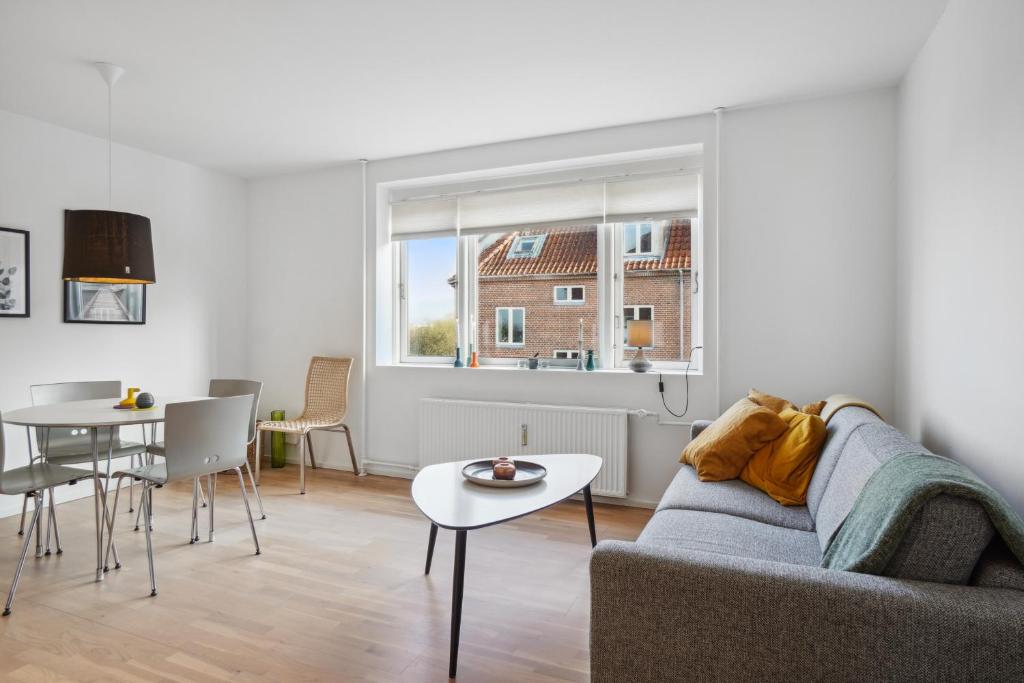 a living room with a couch and a table at Moderne Lejlighed i Aalborg Vestby - 1 BR in Aalborg