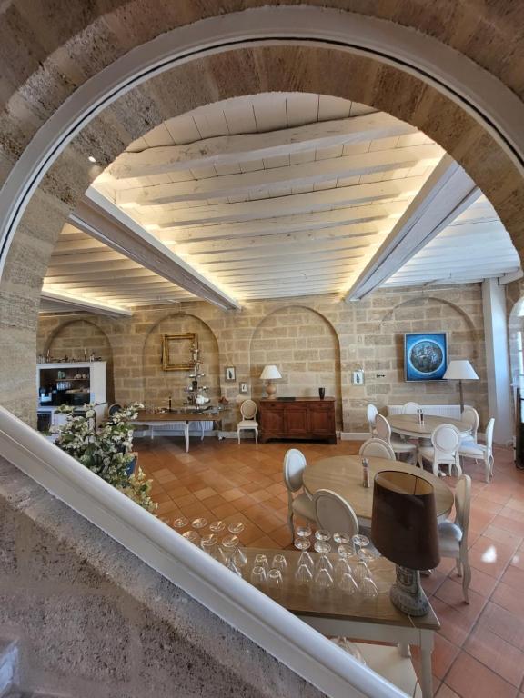 an archway in a room with chairs and tables at Pavillon des Millésimes in Lussac