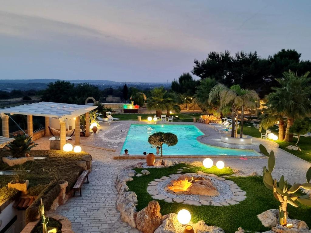 an outdoor swimming pool with lights and a resort at Villa Liquattruvienti in Leuca