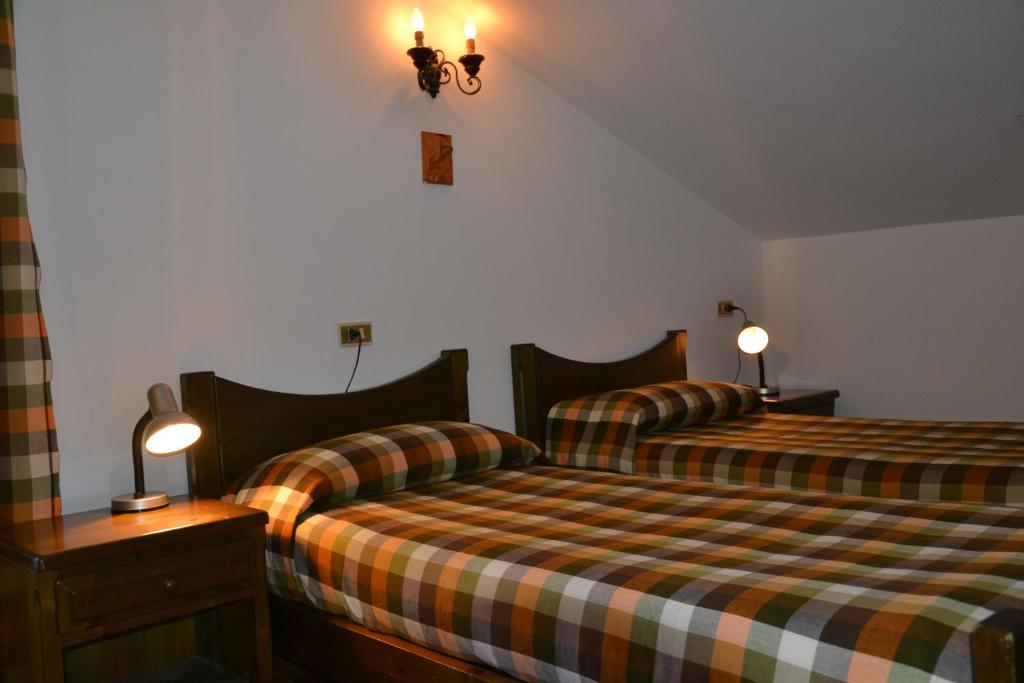 Postel nebo postele na pokoji v ubytování ALBERGO VALLUNGA