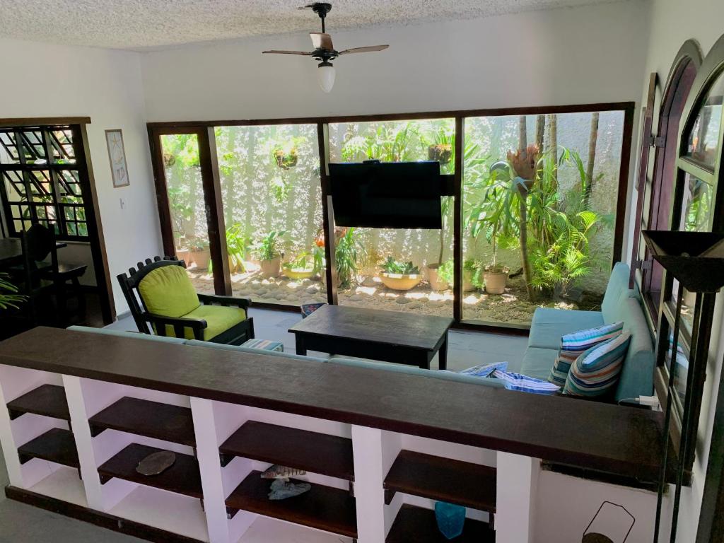 a living room with a table and some chairs at Hostel Vila dos Corais in Arraial do Cabo