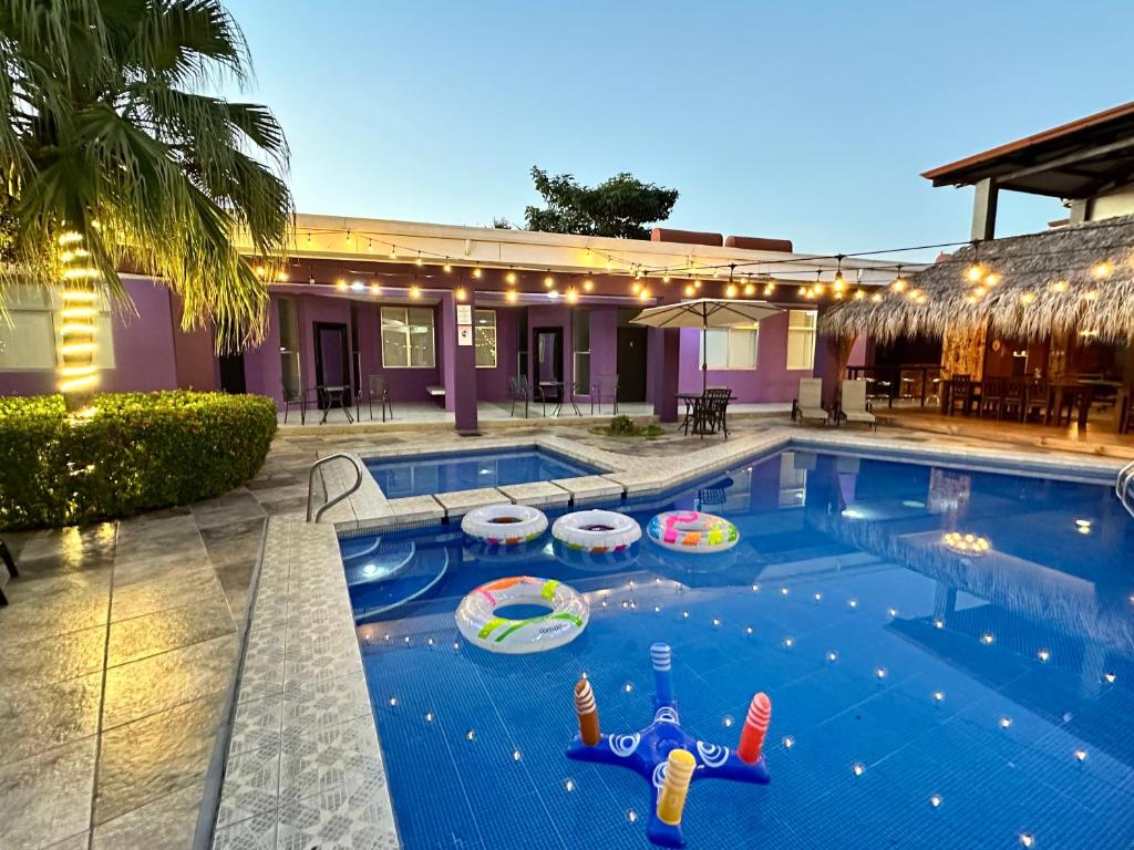 a swimming pool with a pool toy in the middle at Tropical Paradise in Jacó