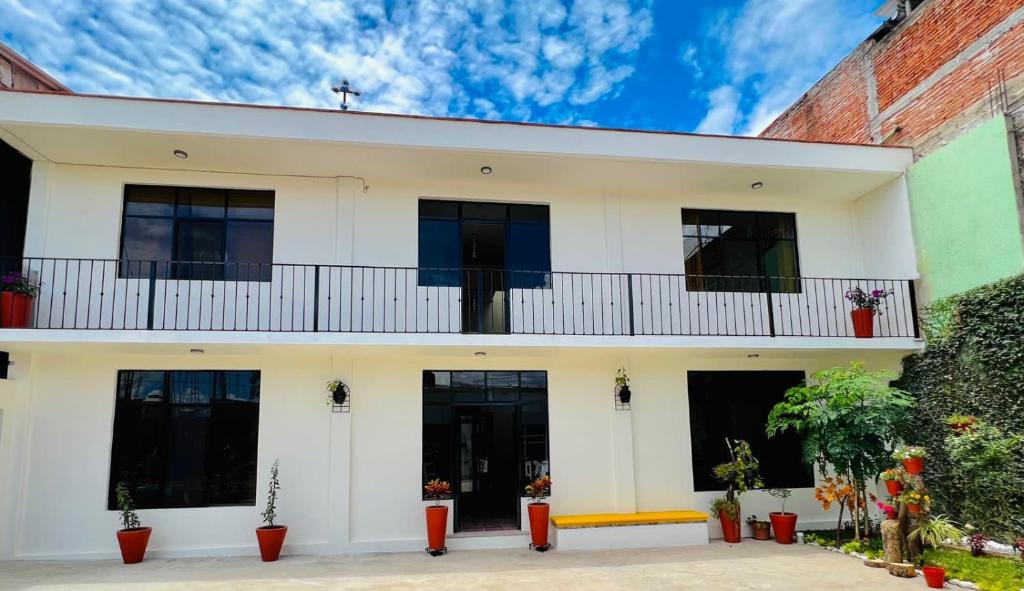 een wit huis met een balkon en planten bij Casa EL Mundo 'Jalatlaco' in Oaxaca City