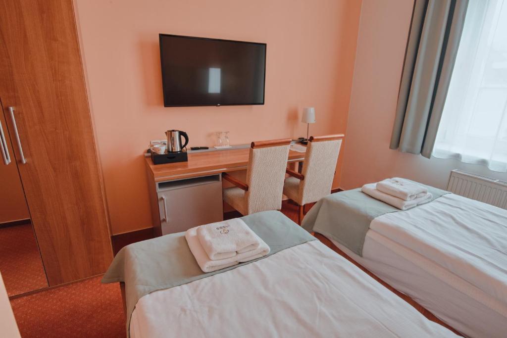 Postel nebo postele na pokoji v ubytování Hotel Grand