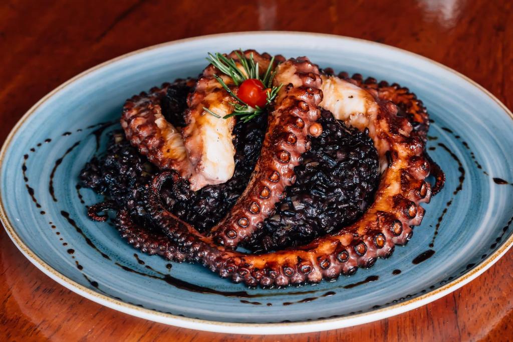 a blue plate of food on a wooden table at Costao do Santinho Resort All Inclusive in Florianópolis