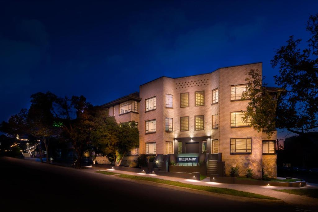 a large brick building with lights in front of it at Crest On Barkly Serviced Apartments in Melbourne