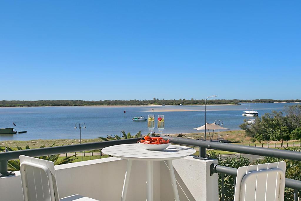 a dining room table with a view of the water at Sandcastles On The Broadwater in Gold Coast