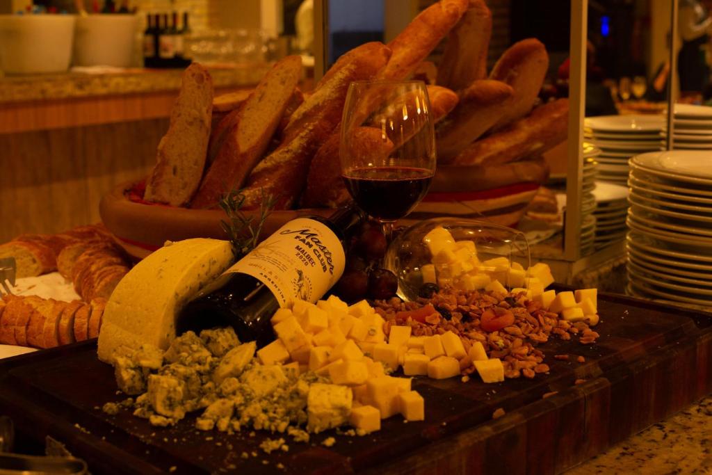 a table with wine glasses and cheese and bread at Costao do Santinho Resort All Inclusive in Florianópolis