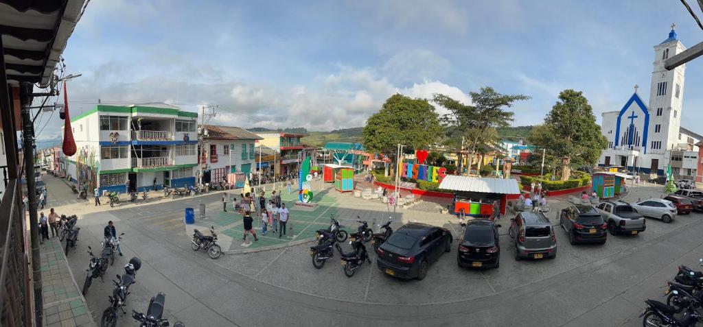 a busy city street with cars parked in a parking lot at Villa Anny in Quebradagrande