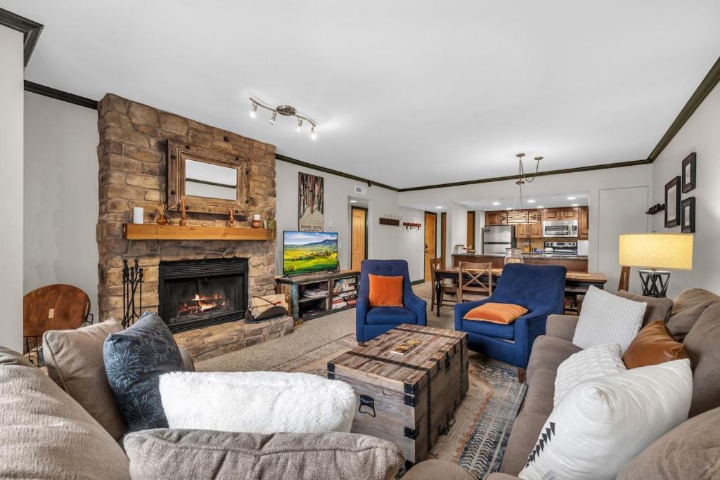 a living room with a couch and a fireplace at Modern 2BR Condo Near Ski Lift Walk Everywhere in Park City