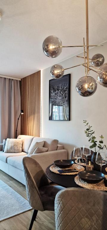 a living room with a couch and a table at Juuri valmistunut kaksio upealla Logomon alueella. in Turku
