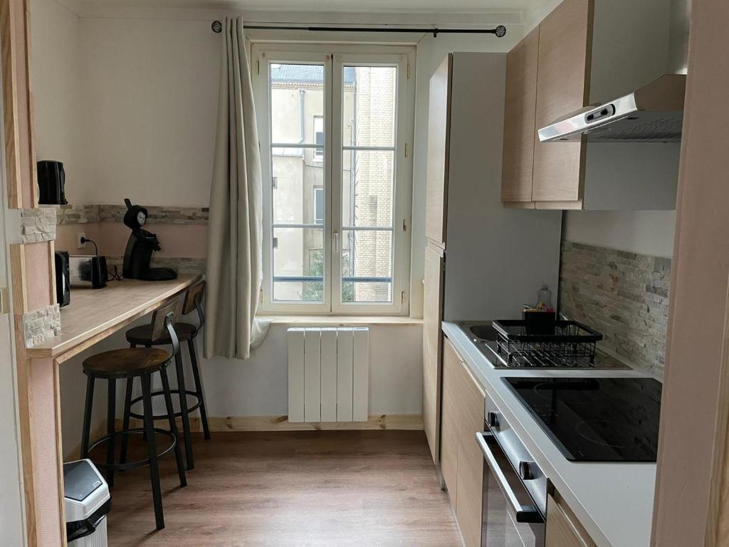 a small kitchen with a window and a stove top oven at Place St Vincent de Paul, Le Havre in Le Havre