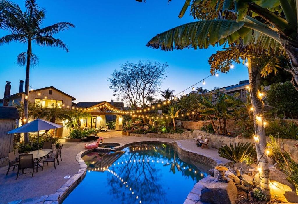a backyard with a swimming pool and a house at Resort style back yard heated pool and spa in Encinitas